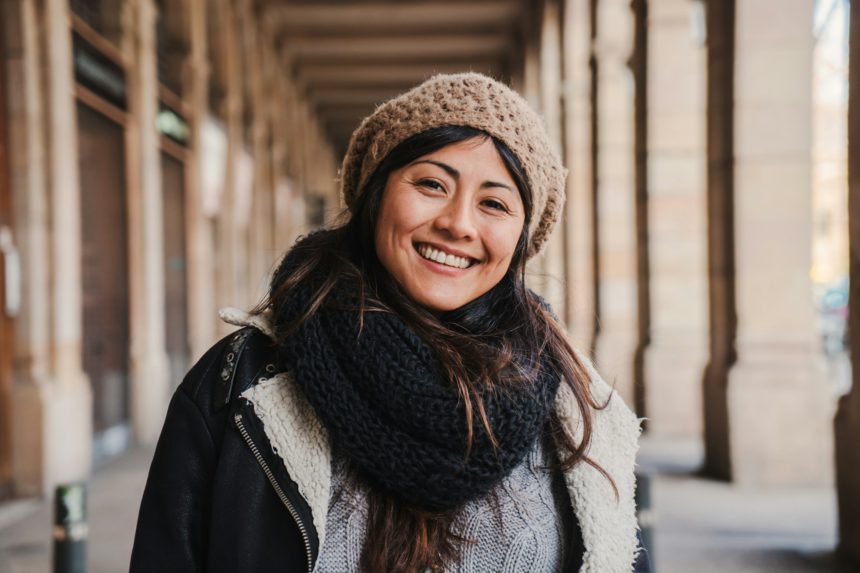 Front view of asian young woman smiling with white perfect teeth and positive attitude. Close up