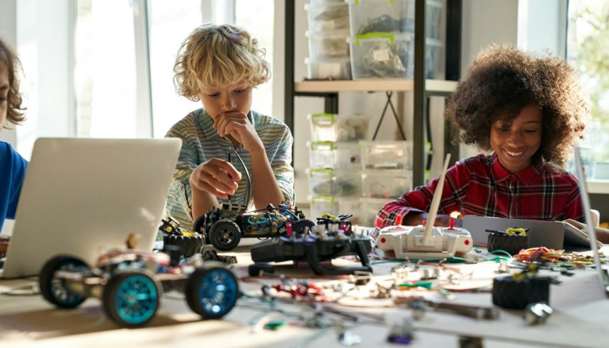 Group of diverse schoolkids on STEM science engineering educational class.