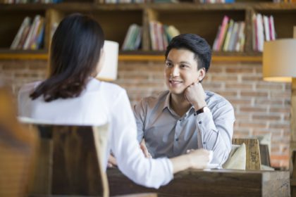 Young woman and man talking in cafe